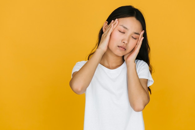 Tired Asian Woman With Orange Background Photo Free Download