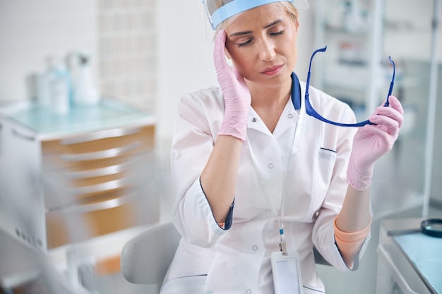 Premium Photo | Tired female dentist after working in office