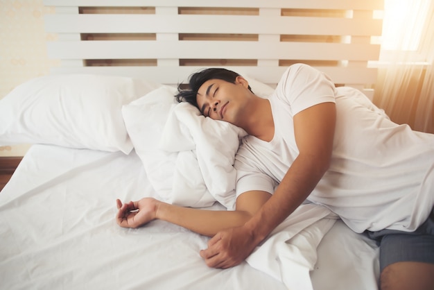 Free Photo | Tired man lying down sleep to bed