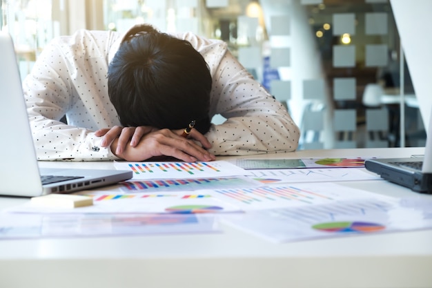 Tired overworked businessman sleeping Free Photo