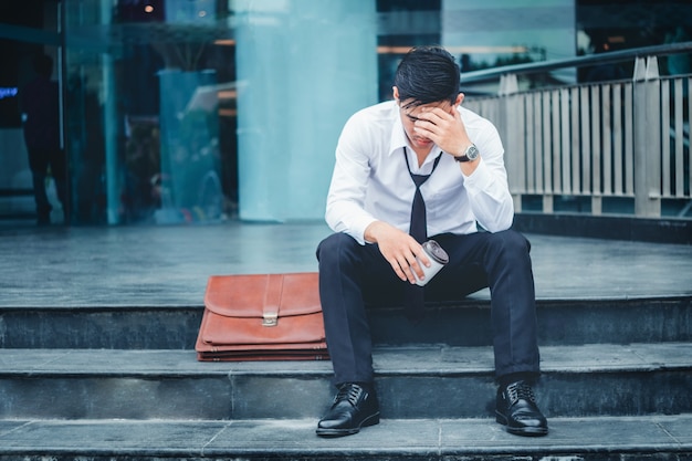 Premium Photo Tired Or Stressed Businessman Sitting On The Walkway