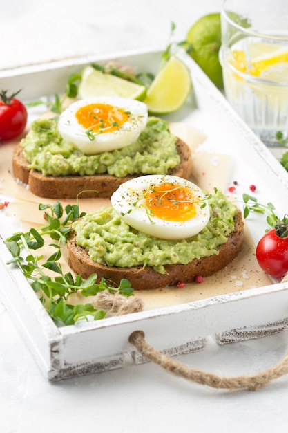 Premium Photo | Toast with avocado puree and soft-boiled egg on white ...