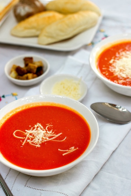 Free Photo | Tomato soup served with grated cheese and crackers