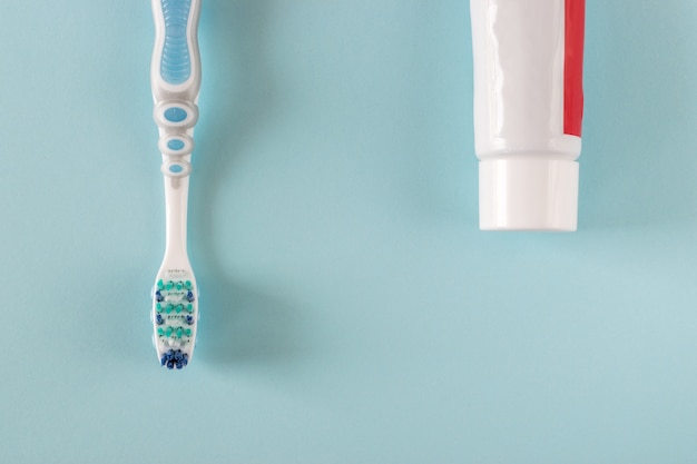 Premium Photo | Toothbrush and toothpaste on bright blue background