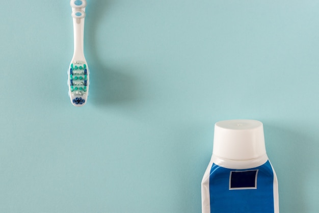 Premium Photo | Toothbrush and toothpaste on bright blue background