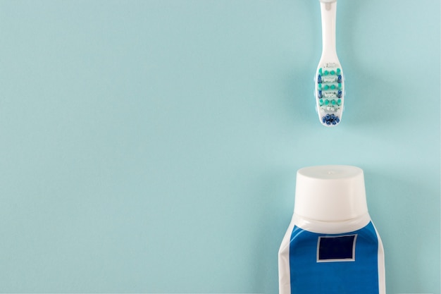 Premium Photo | Toothbrush and toothpaste on bright blue background