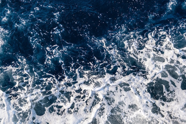 Premium Photo | Top down aerial view of sea water surface. white foam ...