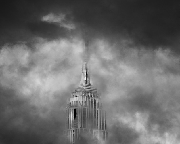 The top of a skyscraper surrounded with clouds | Free Photo