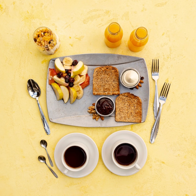 Top view arrangement with tasty breakfast and yellow background Free Photo