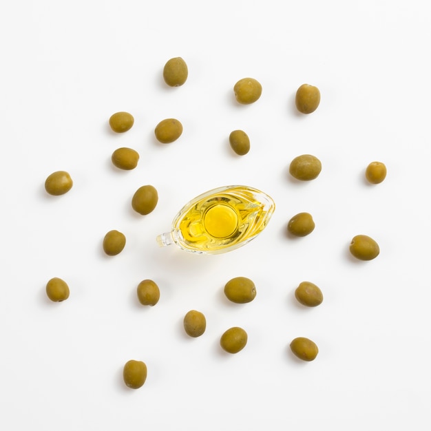 Top view of bottle with oil and green olives Free Photo