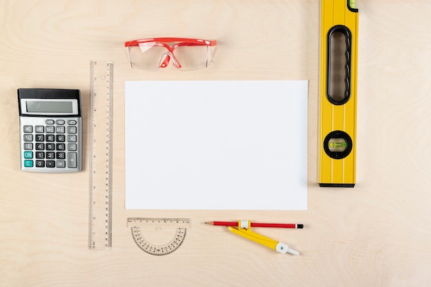 Top view of builder desk with blank paper sheet Free Photo