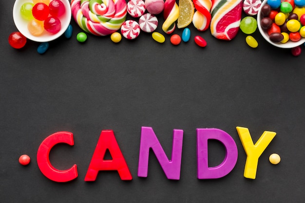 Free Photo | Top view candy lettering with tasty sweets