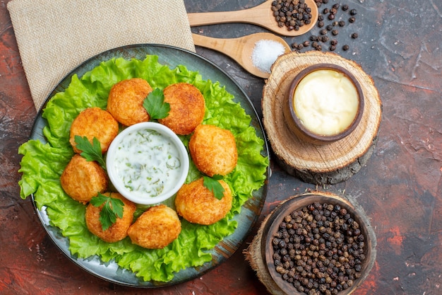 Free Photo | Top view chicken nuggets lettuce on plate salt and black ...