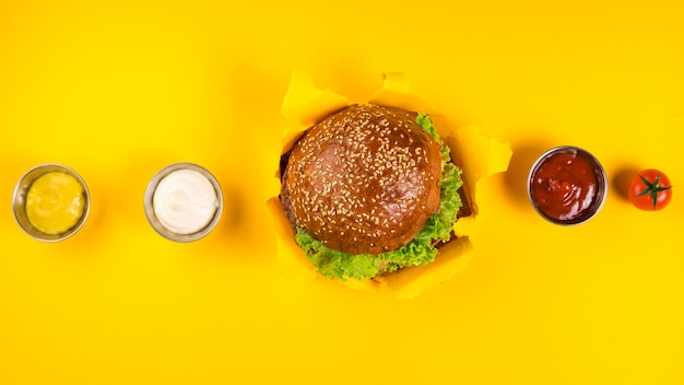 Top view classic burger with various dips Free Photo