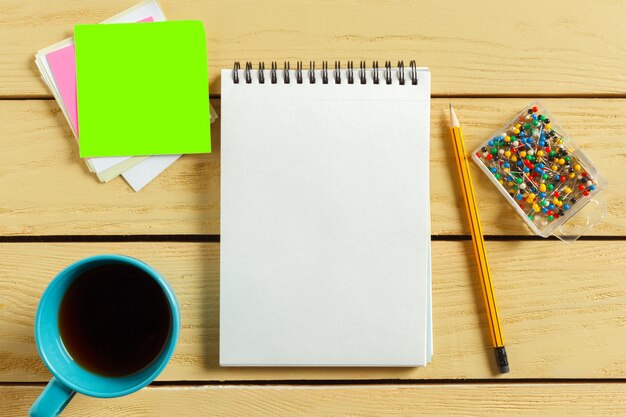 Top view. coffee cup with coffee. pen putting on blank notebook. Premium Photo