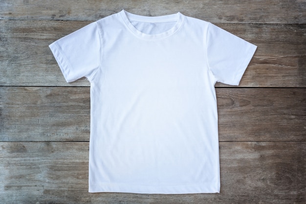 Top view of color t-shirt on grey wood plank background Photo | Premium ...