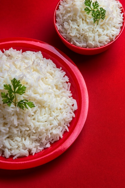 Premium Photo | Top view of cooked plain white basmati rice in red bowl ...