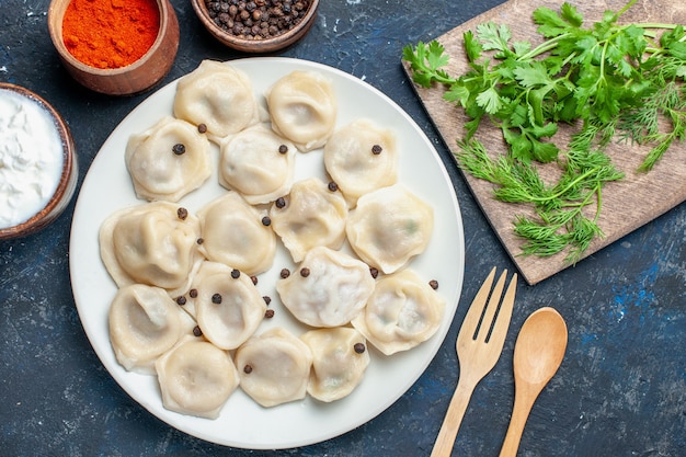 Free Photo | Top view of delicious baked dumplings inside plate along ...