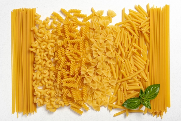 Top view of different types of pasta on plain background Photo | Free ...