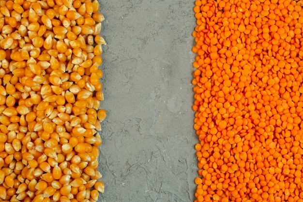 Free Photo Top View Of Dried Corn Seeds And Red Raw Lentils With Copy Space On Grey