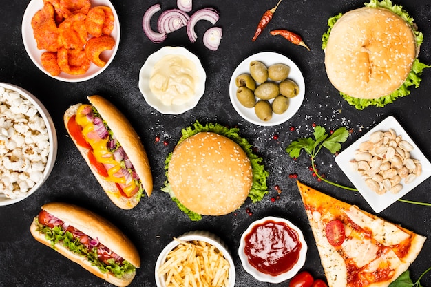 Top view of fast food meal on black table Photo | Free Download