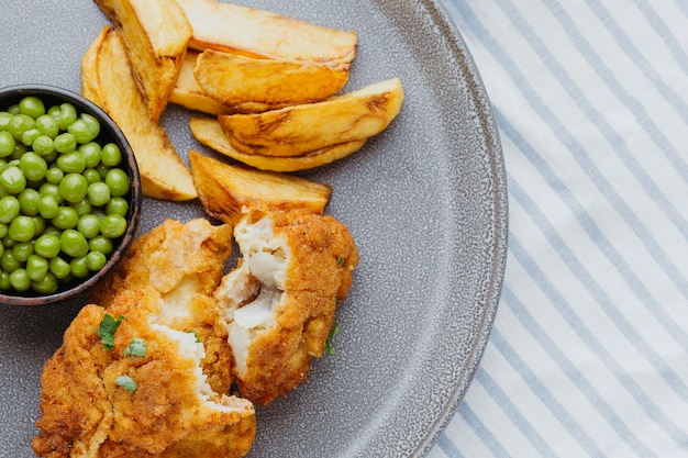 Free Photo | Top view fish and chips with peas on plate