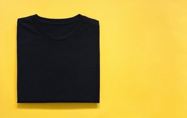 Premium Photo | Top view of folded black color t-shirt