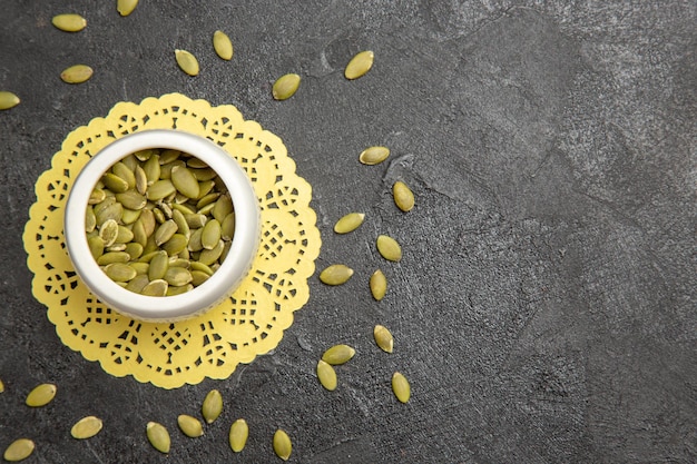 free-photo-top-view-fresh-pumpkin-seeds-on-the-dark-background-seed