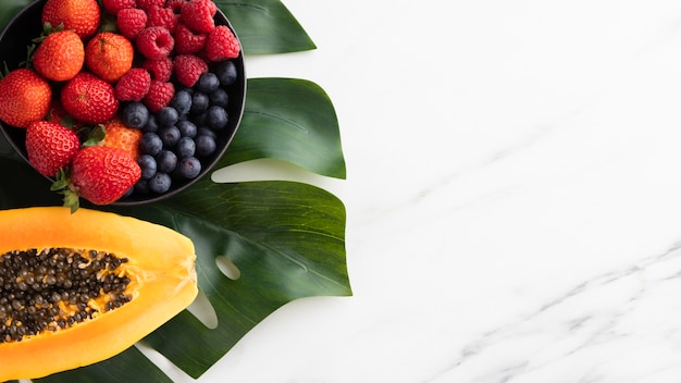 Free Photo | Top view of fruit bowl with papaya and copy space