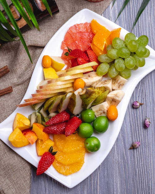 Free Photo | Top view fruit plate orange strawberry banana kiwi pear ...