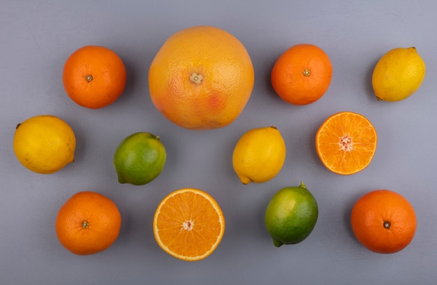 Free Photo Top View Grapefruit With Oranges Lemons And Limes On Gray Background