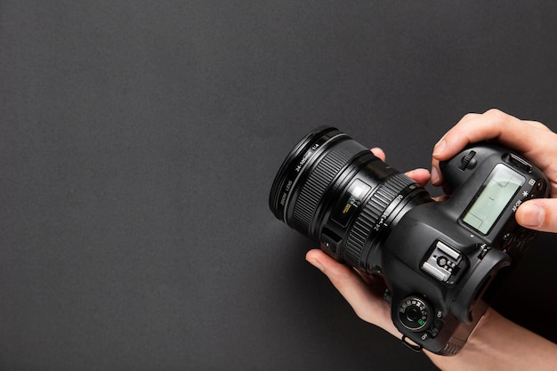 Top view of hands holding a camera with copy space Free Photo