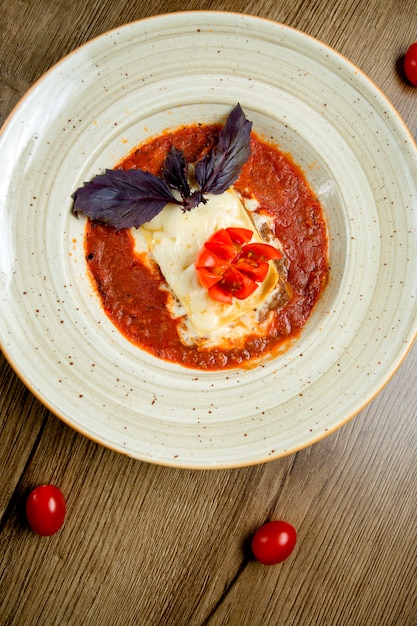 Free Photo | Top view of italian lasagne plate in tomato sauce ...