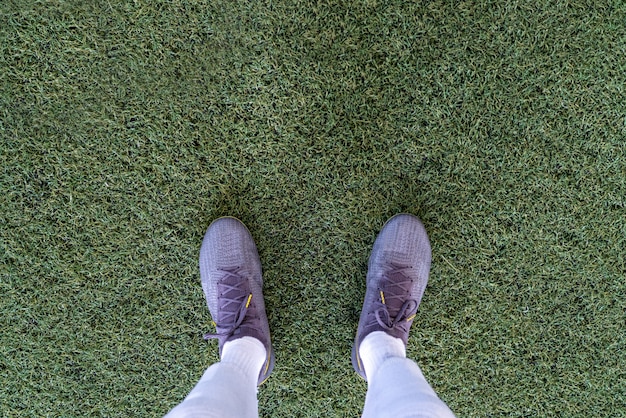 Premium Photo | Top view of leg wearing stud in the football field in a ...