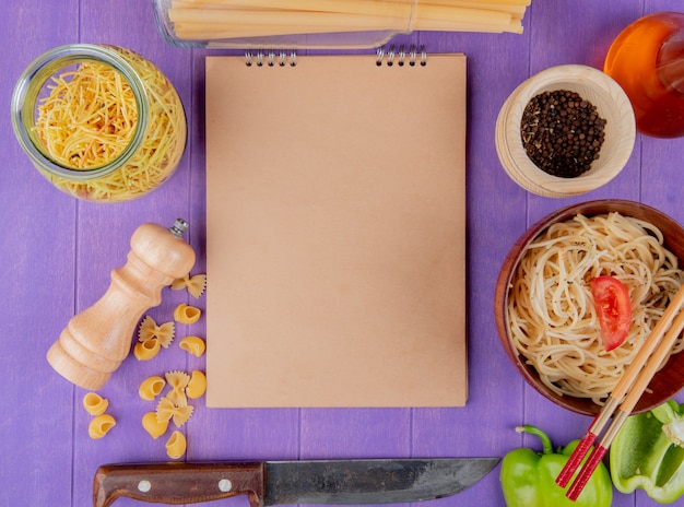 Download Free Photo Top View Of Macaronis As Cooked And Uncooked Spaghetti Farfalle Pipe Rigate Bucatini With Black Pepper Butter Pepper Knife Around Note Pad On Purple Background With Copy Space