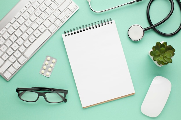 Top View Of Medical Accessories On Green Desk Free Photo