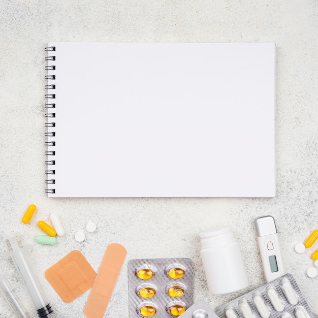 Free Photo | Top view medical elements assortment with empty notepad