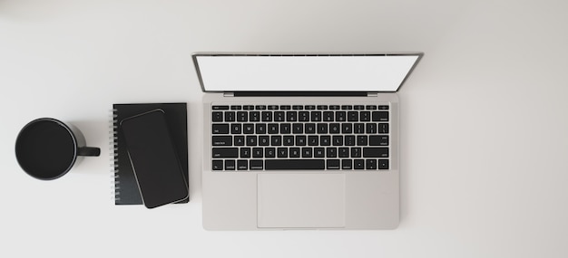 Top view of modern workspace with laptop computer, notebook and coffee cup Premium Photo