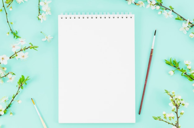 Top view notebook with flower branches Free Photo