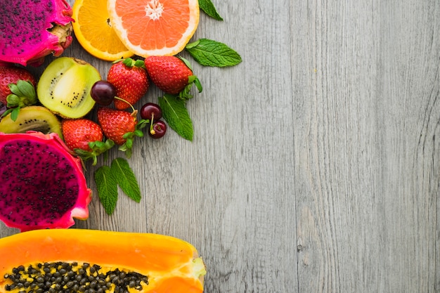 Top view of delicious fruits on wooden surface Free Photo