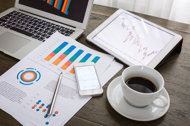 Top view of financial reports next to a cup of coffee Free Photo Top view of financial reports next to a cup of coffee Free Photo