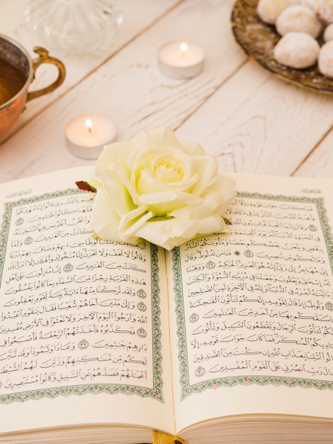 Premium Photo Top View Opened Quran With White Rose