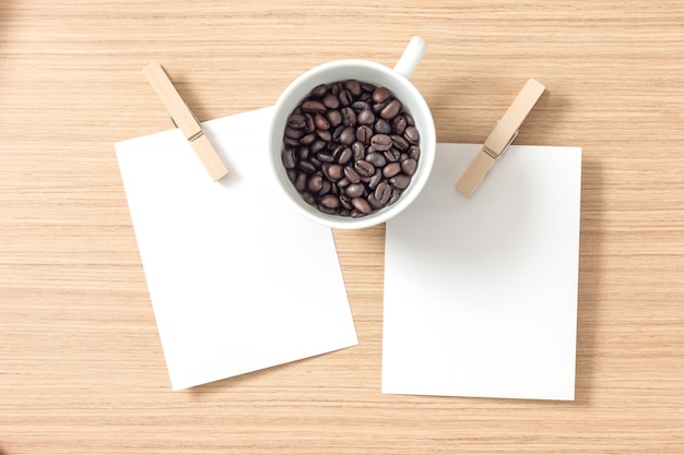 Top view of paper or cardboard with clothes pegs and coffee bean Premium Photo