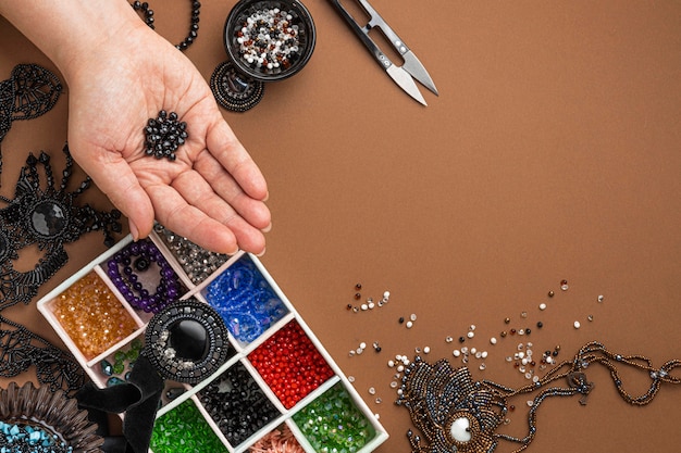 Free Photo | Top view of person doing bead work