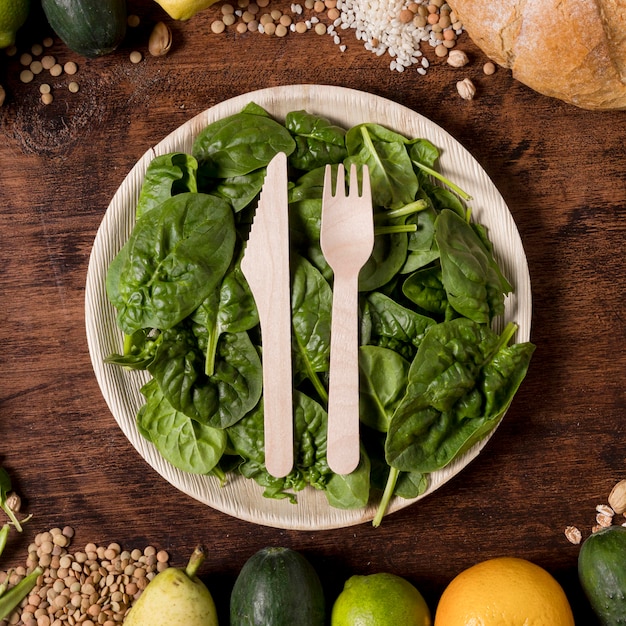 Top view plate with spinach leaves Free Photo