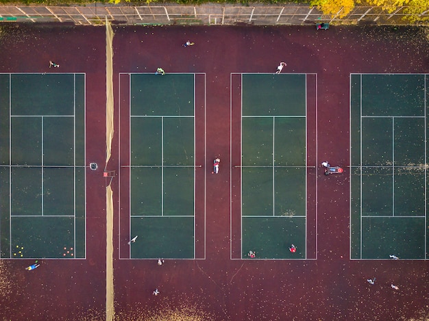 Premium Photo | Top view play tennis on several courts aerial drone shot