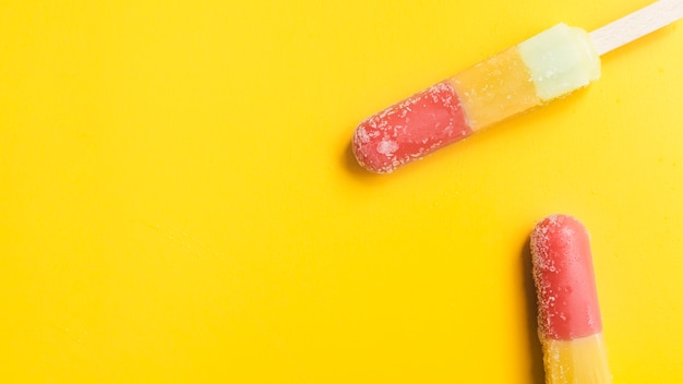 Download Premium Photo Top View Of Popsicles On Yellow Canvas PSD Mockup Templates