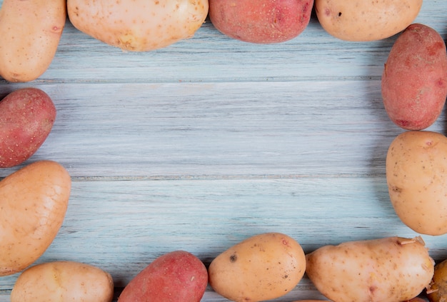 Free Photo Top View Of Russet And Red Potatoes Set In Square Shape On Wood With Copy Space