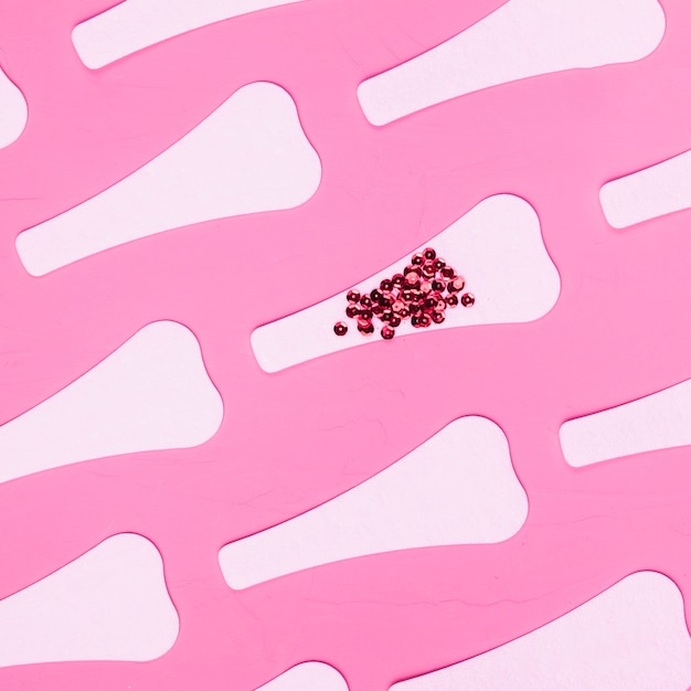 Top view sanitary towels pattern with sequins Free Photo