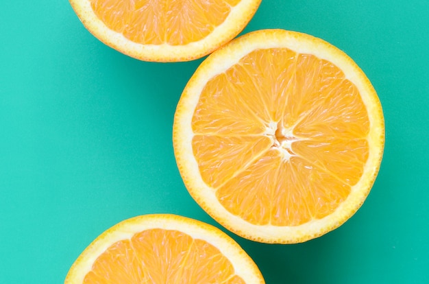 Premium Photo | Top view of a several orange fruit slices on bright ...